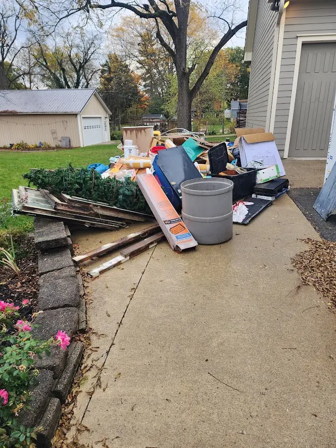 Dumpster being loaded with debris for Commercial Dumpster Rental in Sugarmill Woods